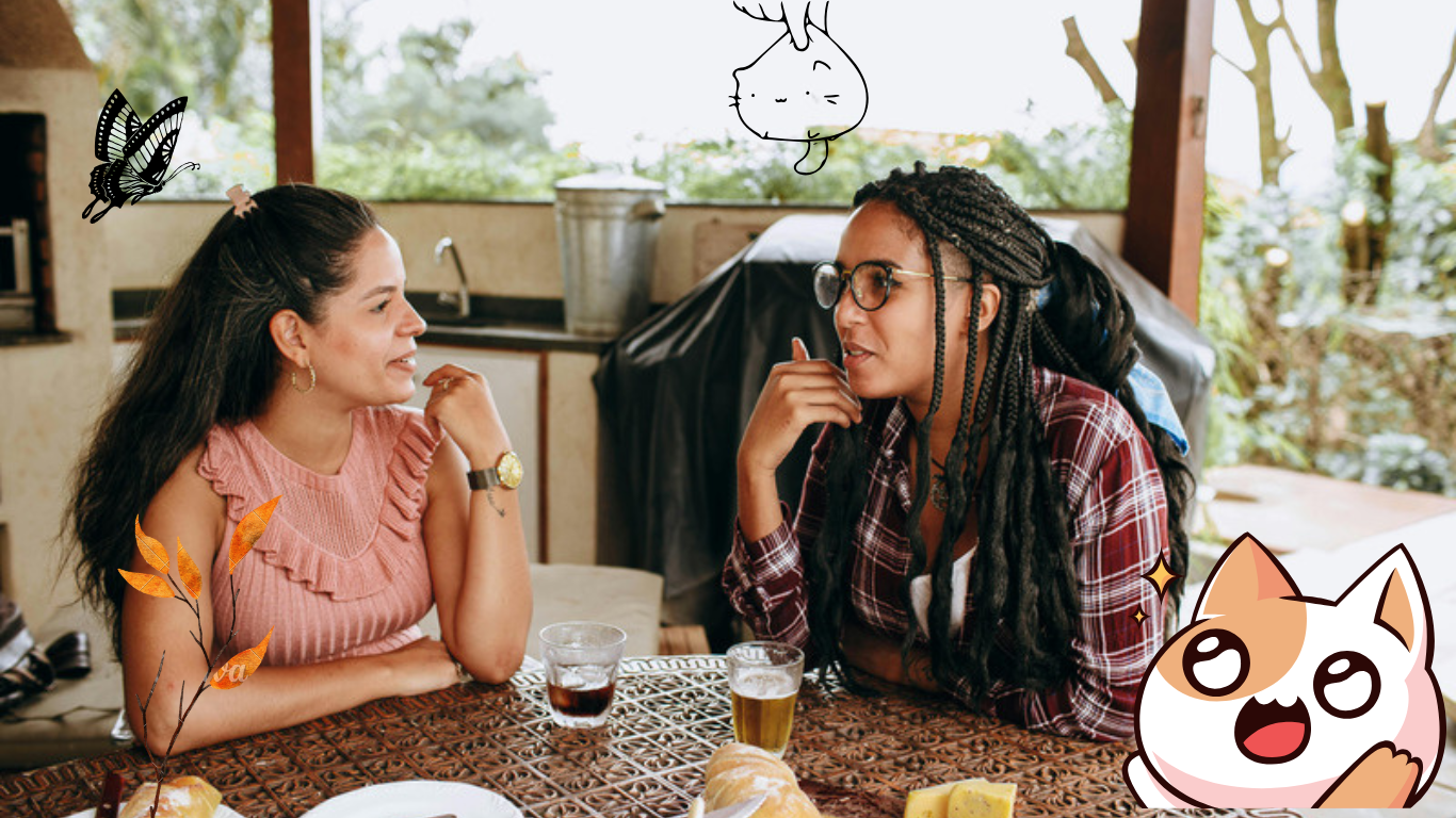 Digital Marketing Agency for Women Entrepreneurs | Two women sitting at a table with drinks, engaged in conversation, with cartoon characters in the corner.